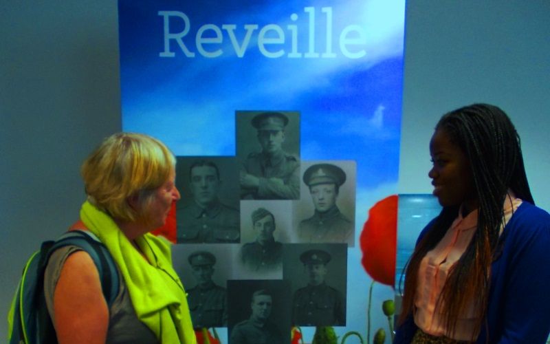 Project Volunteer Kasongo Swana and library regular Isabel Butler discuss Reveille 