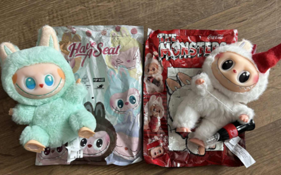 Two Labubu dolls with packaging.