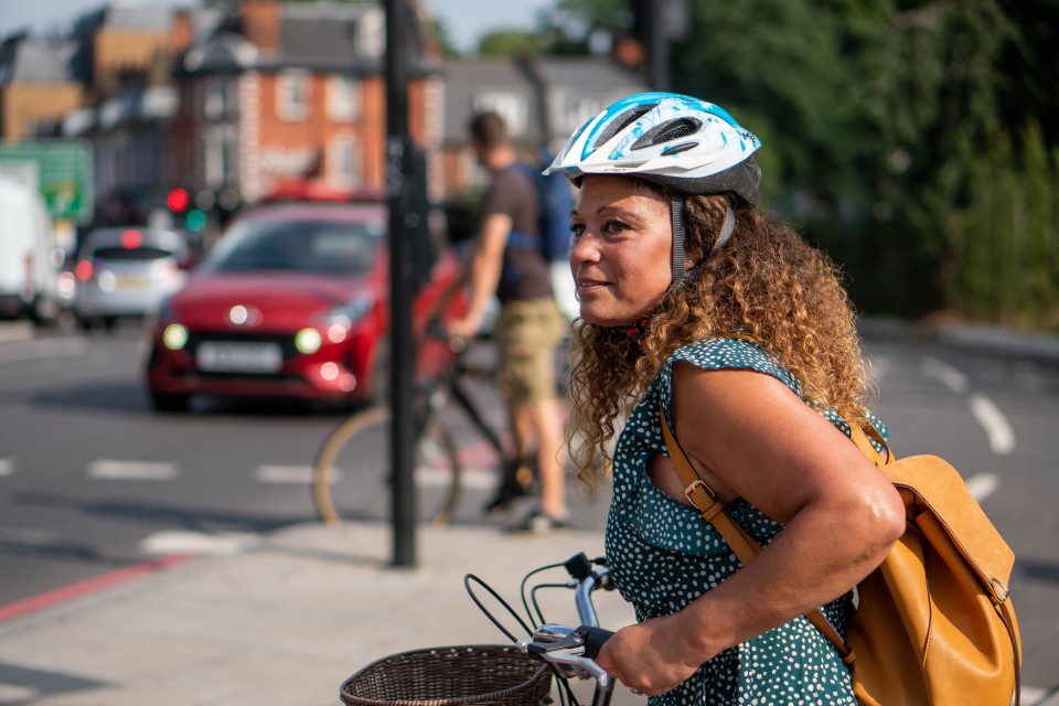 woman with bike urban street