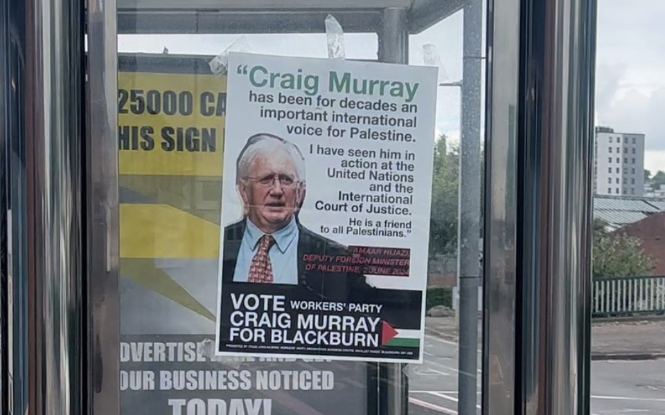 Image that shows a poster of Craig Murray on a bus shelter