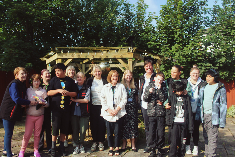 An image of a group of people standing outside